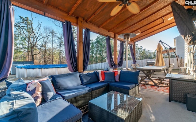 view of patio with an outdoor living space and a covered pool