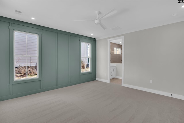 unfurnished room featuring ceiling fan and light carpet