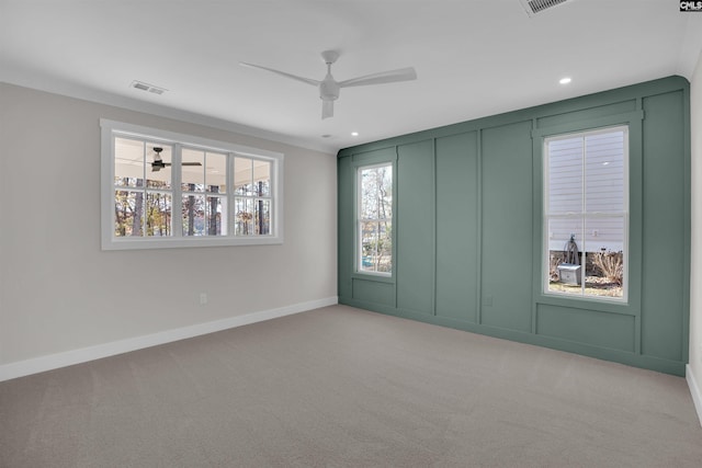 unfurnished room featuring ceiling fan, crown molding, and light colored carpet