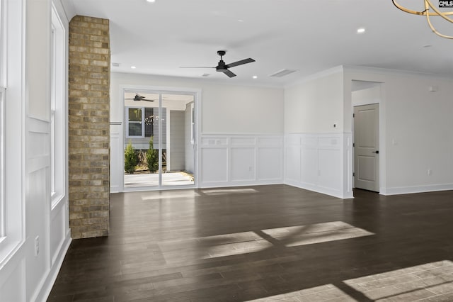 spare room with ceiling fan, crown molding, and dark wood-type flooring