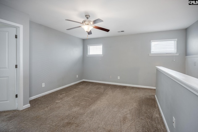 empty room with carpet flooring and ceiling fan