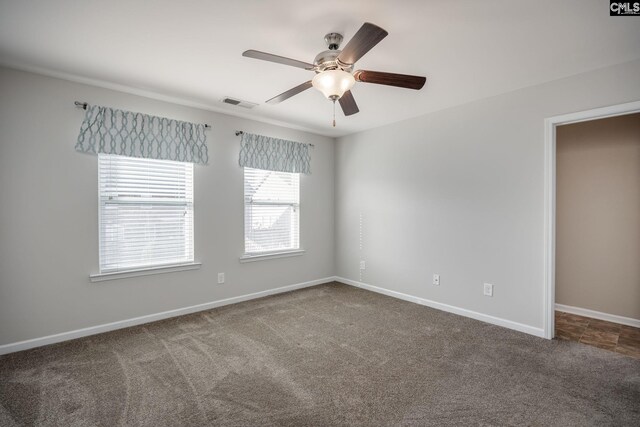 spare room featuring ceiling fan and carpet floors