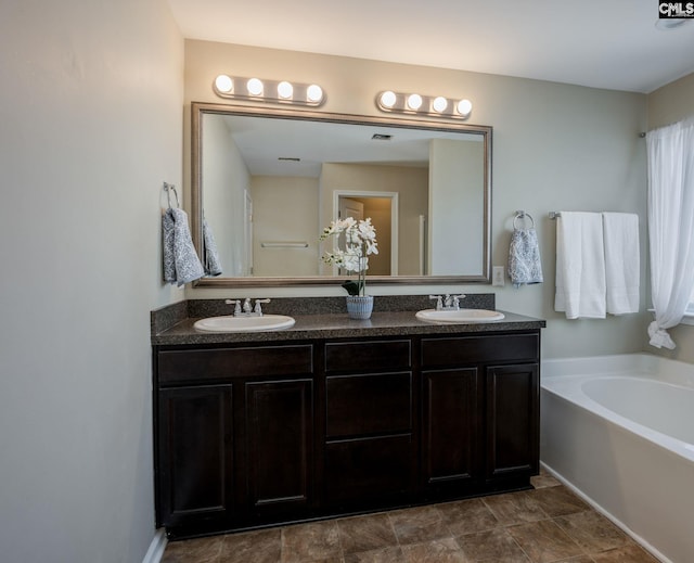 bathroom with a bath and vanity