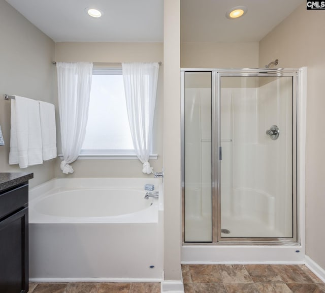 bathroom with plus walk in shower and vanity