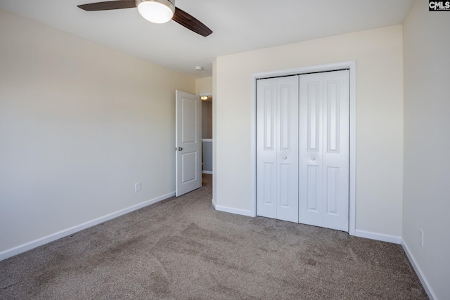 unfurnished bedroom with carpet floors, a closet, and ceiling fan