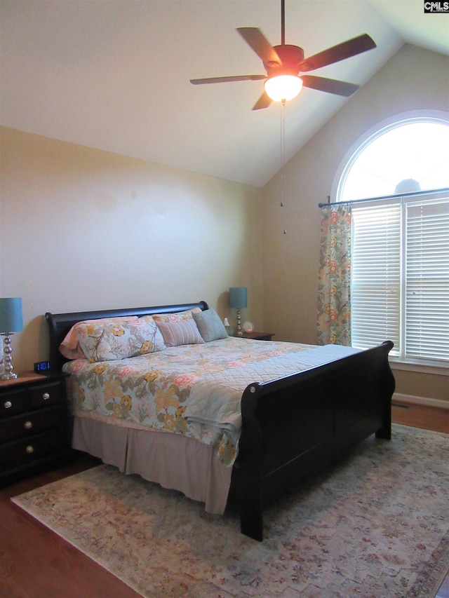 bedroom with hardwood / wood-style floors, ceiling fan, and vaulted ceiling