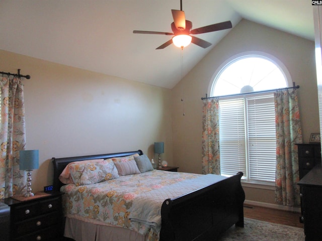 bedroom featuring multiple windows, ceiling fan, vaulted ceiling, and hardwood / wood-style flooring