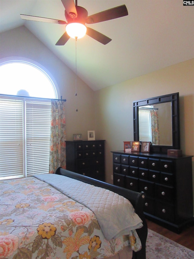 bedroom featuring ceiling fan, wood-type flooring, and vaulted ceiling