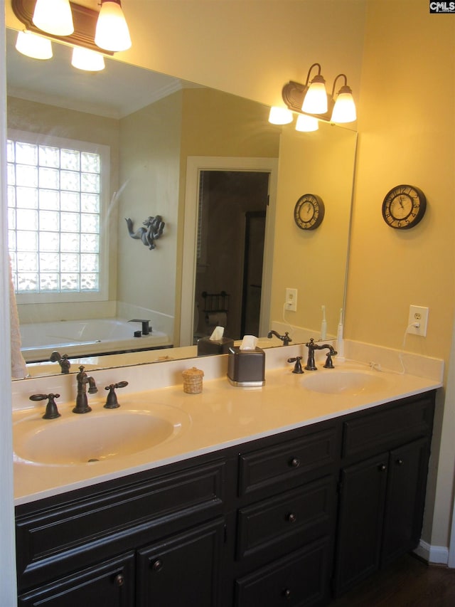 bathroom with a tub to relax in, crown molding, and vanity