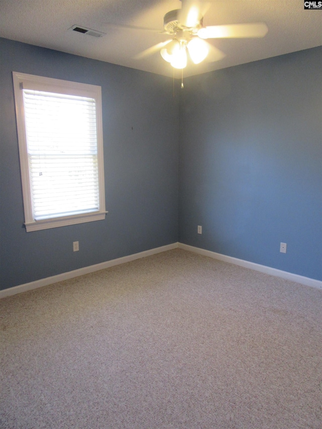 unfurnished room with carpet flooring and ceiling fan