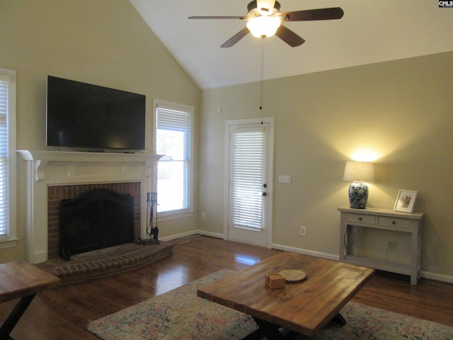 living room with ceiling fan, lofted ceiling, a fireplace, and dark wood-type flooring