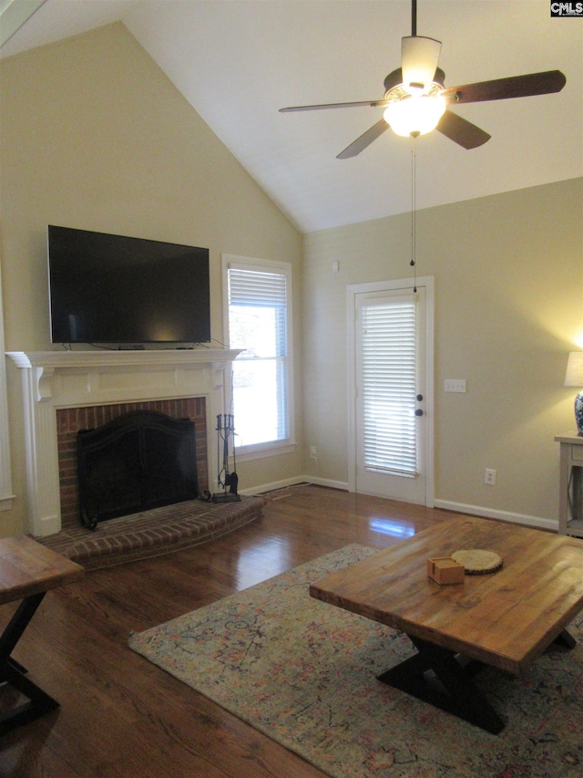 living room with hardwood / wood-style floors, ceiling fan, a fireplace, and vaulted ceiling