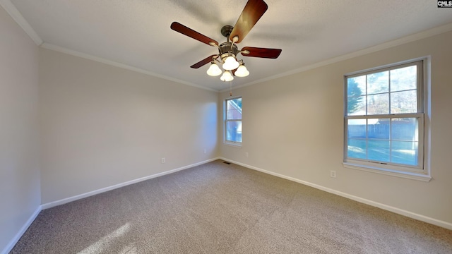 empty room with carpet flooring, ceiling fan, and crown molding