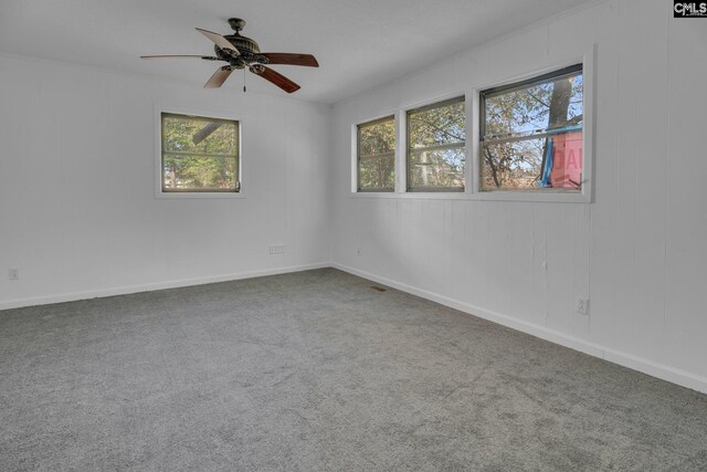 carpeted empty room featuring ceiling fan