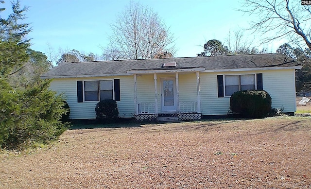 ranch-style home featuring a front yard