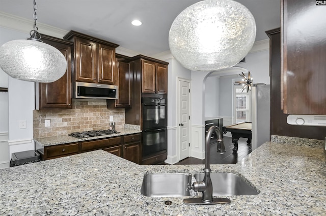 kitchen featuring dark brown cabinetry, sink, stainless steel appliances, and pool table