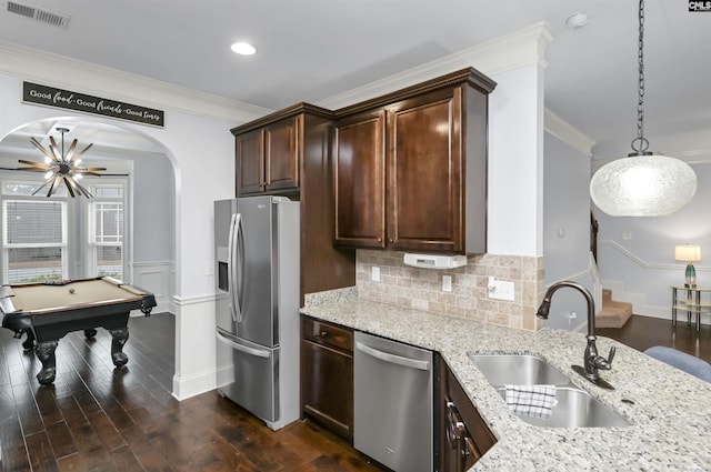 kitchen with sink, hanging light fixtures, stainless steel appliances, billiards, and ornamental molding