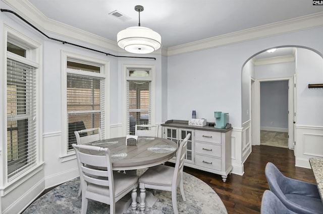 dining space featuring dark hardwood / wood-style floors and crown molding