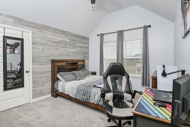 bedroom with carpet flooring, vaulted ceiling, ceiling fan, and wood walls