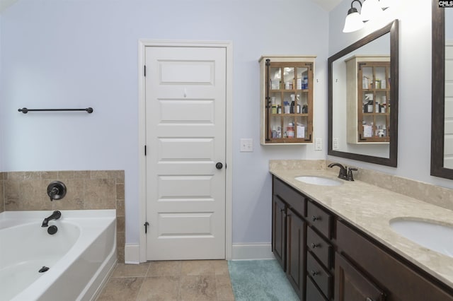 bathroom with tile patterned flooring, vanity, and a bathtub