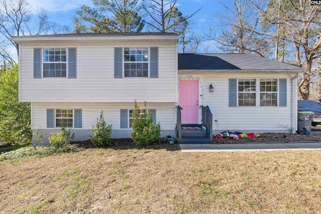 tri-level home with a front yard