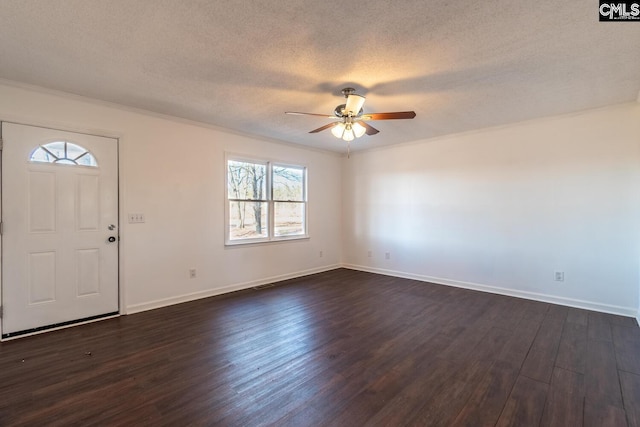 foyer featuring a healthy amount of sunlight, crown molding, ceiling fan, and dark wood-type flooring