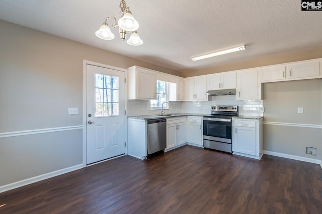 kitchen featuring white cabinets, hanging light fixtures, sink, decorative backsplash, and appliances with stainless steel finishes