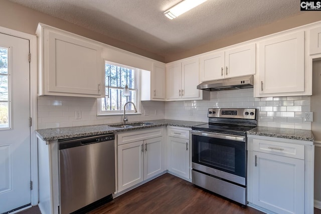 kitchen featuring light stone countertops, appliances with stainless steel finishes, a textured ceiling, sink, and white cabinetry