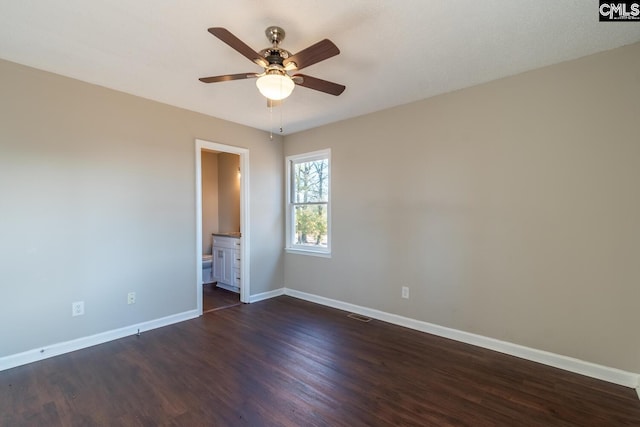 spare room with ceiling fan and dark wood-type flooring