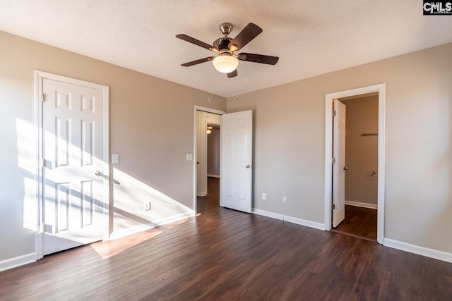 unfurnished bedroom featuring dark hardwood / wood-style floors and ceiling fan