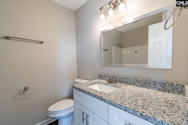 bathroom with a shower, vanity, and toilet