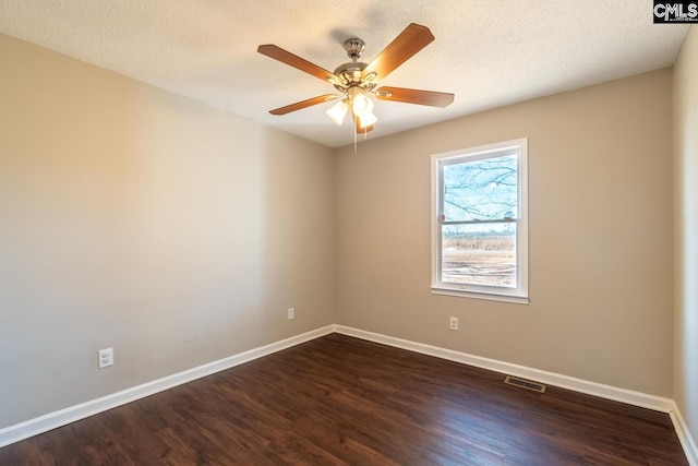 empty room with a textured ceiling, dark hardwood / wood-style floors, and ceiling fan