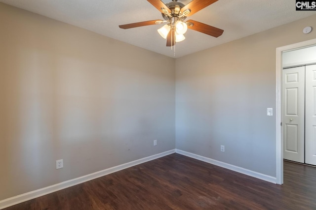 spare room with ceiling fan and dark wood-type flooring