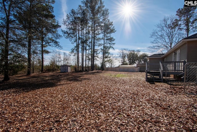 view of yard with a shed and a deck