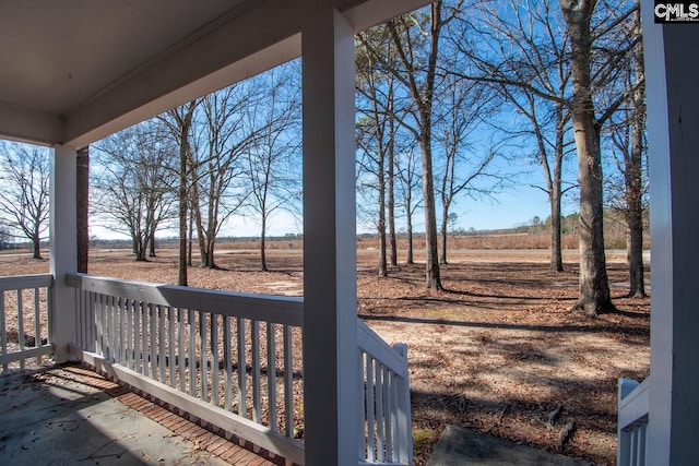 view of yard featuring a rural view and a porch