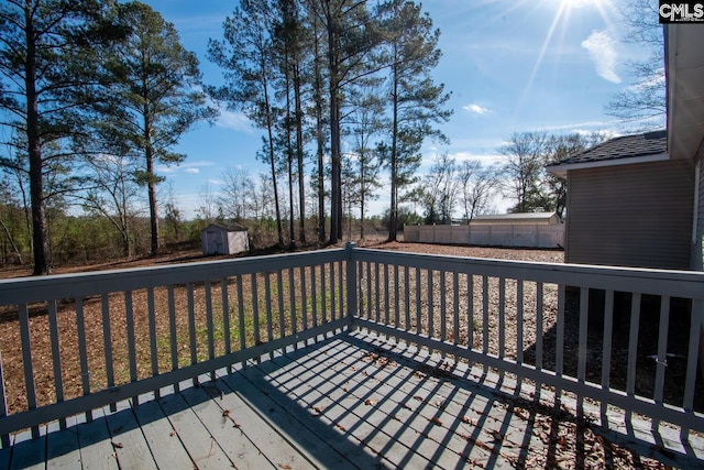 wooden terrace featuring a storage unit