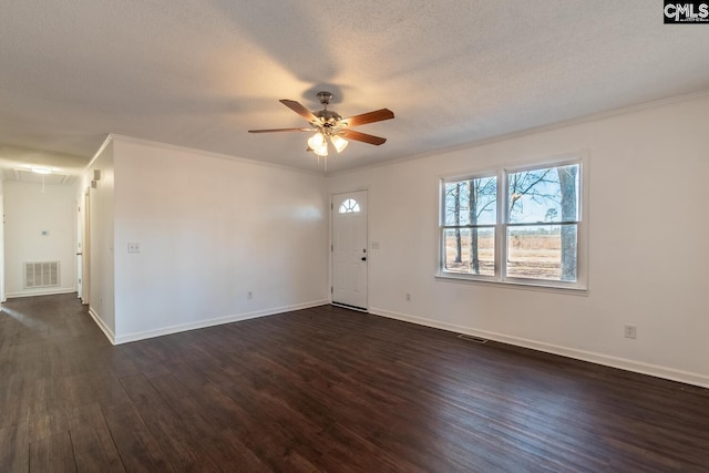 interior space with ceiling fan, dark hardwood / wood-style flooring, a textured ceiling, and ornamental molding