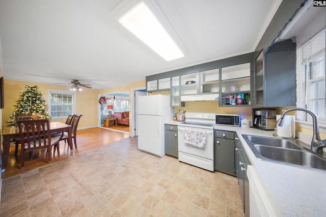 kitchen featuring white appliances, ceiling fan, ornamental molding, and sink