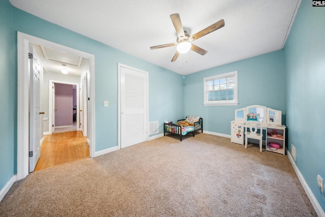 playroom featuring ceiling fan and light carpet