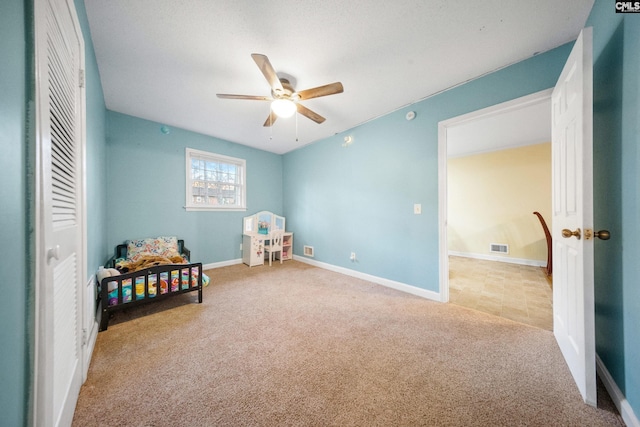 carpeted bedroom with a closet and ceiling fan