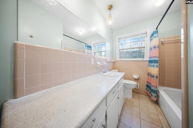 full bathroom featuring shower / bathtub combination with curtain, tile patterned floors, toilet, vanity, and tile walls