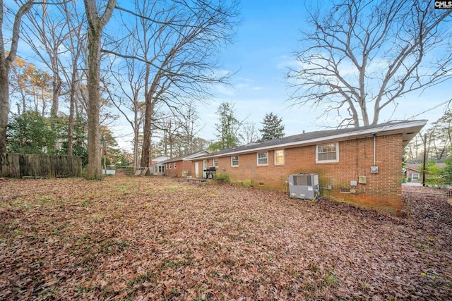 rear view of house featuring central AC unit