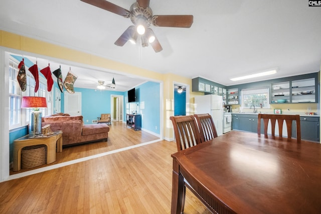 dining area with sink and light wood-type flooring