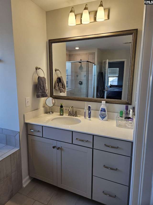 full bath featuring tile patterned flooring, connected bathroom, a stall shower, and vanity