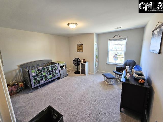 bedroom with carpet, visible vents, and baseboards