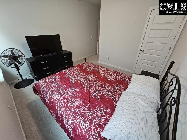 bedroom featuring carpet flooring and baseboards