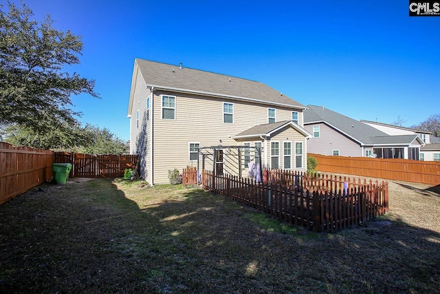 rear view of house featuring a yard