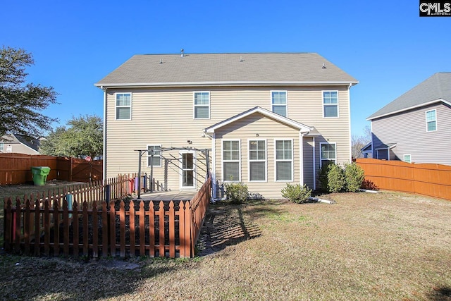 rear view of property featuring a lawn