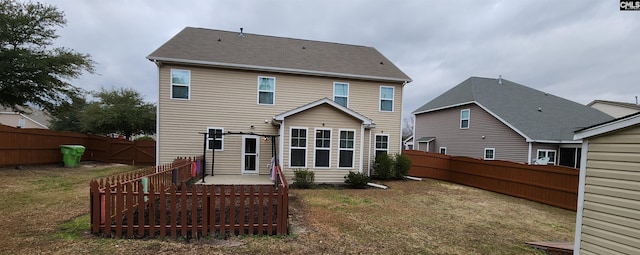 rear view of house with a yard