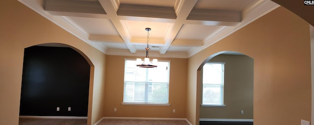 spare room featuring carpet, beam ceiling, crown molding, and coffered ceiling